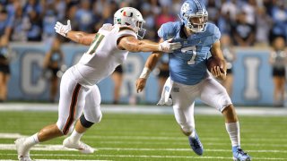 CHAPEL HILL, NORTH CAROLINA – SEPTEMBER 07: Scott Patchan #71 of the Miami Hurricanes pursues Sam Howell #7 of the North Carolina Tar Heels during their game at Kenan Stadium on September 07, 2019 in Chapel Hill, North Carolina. North Carolina won 28-25. (Photo by Grant Halverson/Getty Images)
