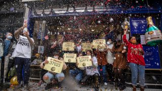 'Doña Manolita' lottery shop owners and employees celebrate after selling the winning ticket number of Spain's Christmas lottery named 'El Gordo' (The Fat One)