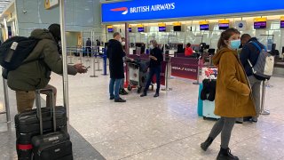 British travelers returning to their homes in Spain wait to speak to airline staff after they were refused entry onto planes, at London's Heathrow airport