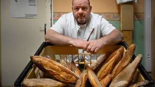 French baker Stephane Ravacley poses in his bakery in Besancon, eastern France, on January 6, 2021. - A baker of Besancon began a hunger strike on January 3, 2021, to keep his Guinean apprentice, a young adult subject to an obligation to leave the French territory (OQTF) and threatened with expulsion.