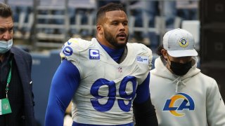 In this Jan. 9, 2021, file photo, defensive end Aaron Donald #99 of the Los Angeles Rams is escorted off the field after an injury during the third quarter of the NFC Wild Card Playoff game against the Seattle Seahawks at Lumen Field in Seattle, Washington.