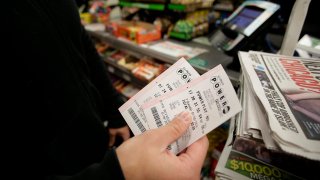 File photo of a person holding Powerball tickets.