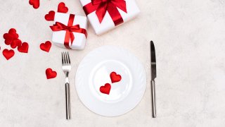 A stock image of a table setting with hearts on the plate