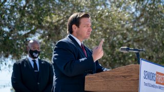 Florida Gov. Ron DeSantis speaks during a press conference at a COVID-19 vaccination site at Anquan Boldin Stadium in Pahokee, Fla., on Wednesday, Feb. 3, 2021. (Greg Lovett/The Palm Beach Post via AP)