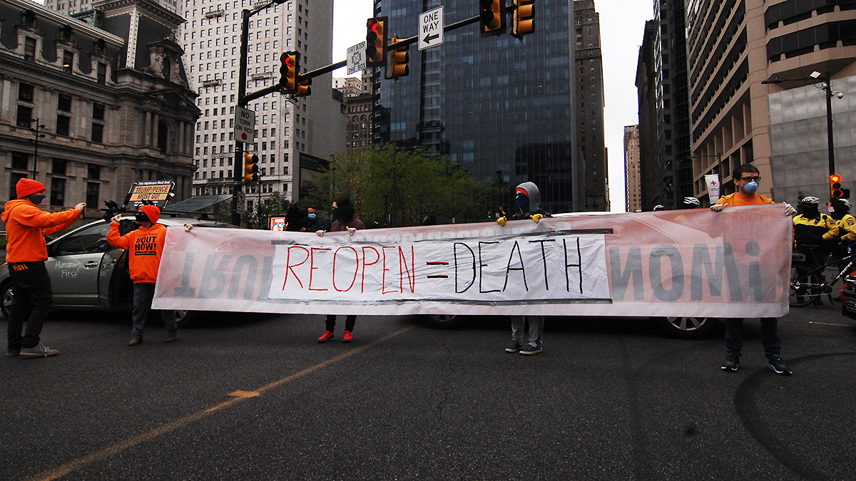 Other protesters urged businesses to stay closed. These marched  in Philadelphia on May 8, 2020.  (Photo by Cory Clark / NurPhoto via Getty Images)