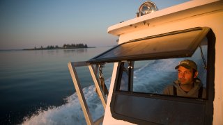 A lobsterman on his boat off the coast of Maine