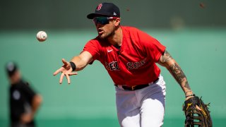 FT. MYERS, FL - FEBRUARY 28: Michael Chavis #23 of the Boston Red Sox tosses the ball during the first inning of a Grapefruit League game against the Atlanta Braves at jetBlue Park at Fenway South on March 1, 2021 in Fort Myers, Florida.