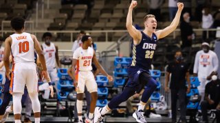In this March 21, 2021, file photo, Francis Lacis #22 of the Oral Roberts Golden Eagles celebrates the Eagles victory over the Florida Gators in the second round of the 2021 NCAA Division I Mens Basketball Tournament held at Indiana Farmers Coliseum in Indianapolis, Indiana.