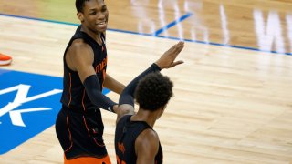 GREENSBORO, NORTH CAROLINA – MARCH 10: Anthony Walker #1 of the Miami Hurricanes reacts with teammate Kameron McGusty #23 following a three point basket during the second half of their second round game against the Clemson Tigers in the ACC Men’s Basketball Tournament at Greensboro Coliseum on March 10, 2021 in Greensboro, North Carolina. (Photo by Jared C. Tilton/Getty Images)