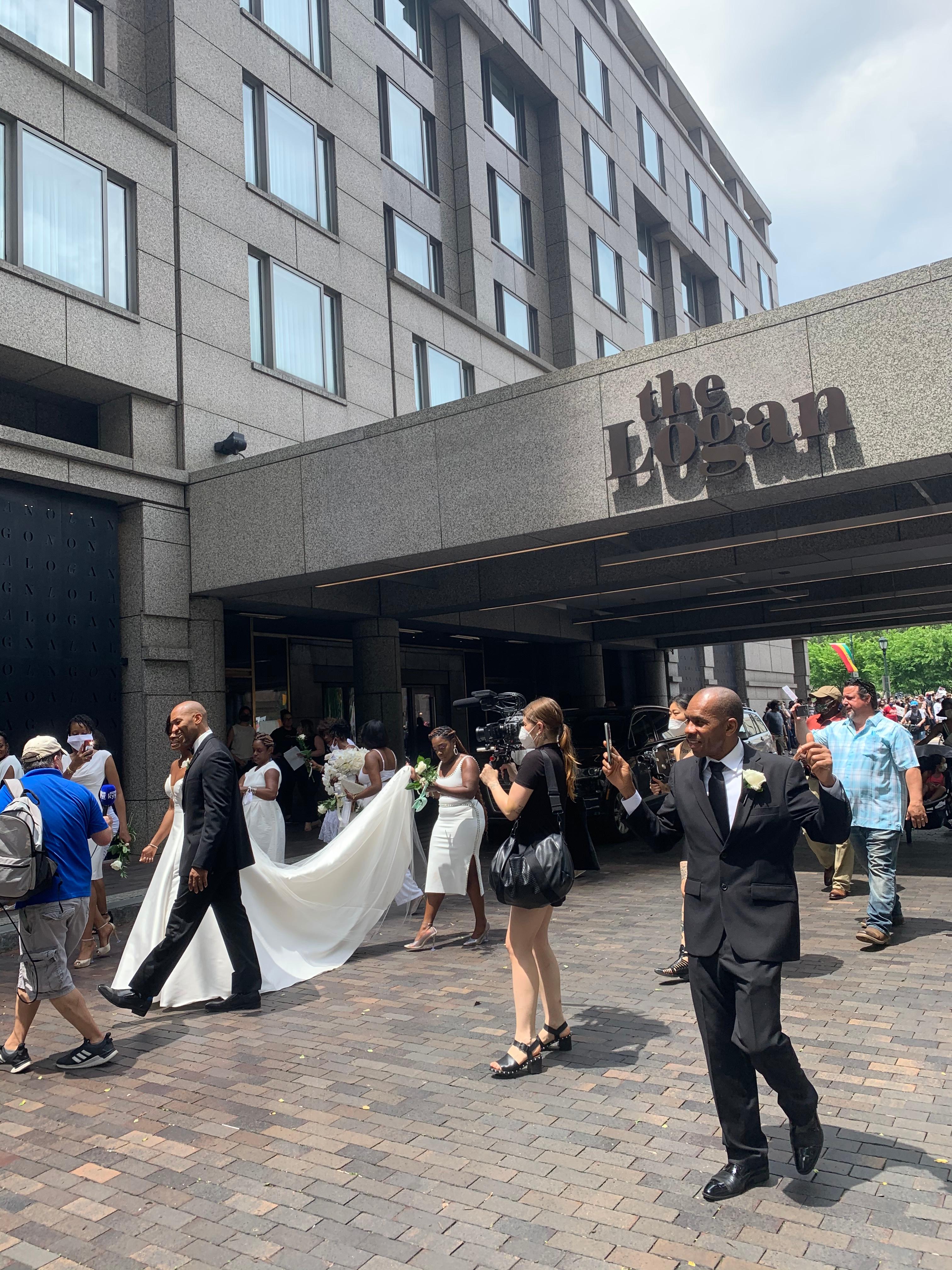 During the protests, a bride and groom getting married at The Logan hotel on the Ben Franklin Parkway left the event to join and show their support. (Photo: Matt Pantaleno / NBC10)