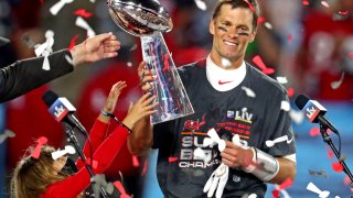 Tampa Bay Buccaneers quarterback Tom Brady (12) celebrates with the Vince Lombardi Trophy after beating the Kansas City Chiefs in Super Bowl LV at Raymond James Stadium.