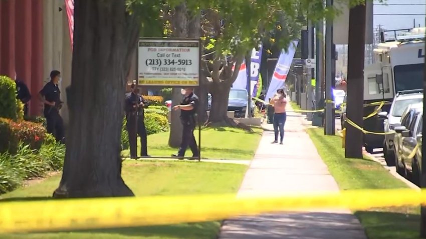 This April 10, 2021, file photo, shows caution tape around the scene where three young children were found stabbed to death in a Reseda apartment.