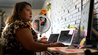 Irma Chavez works in her home office, Tuesday, March 9, 2021, in Springdale, Ark. Chavez came to the United States from her home in El Salvador in 1994 when she was 18 and later was granted temporary protected status.
