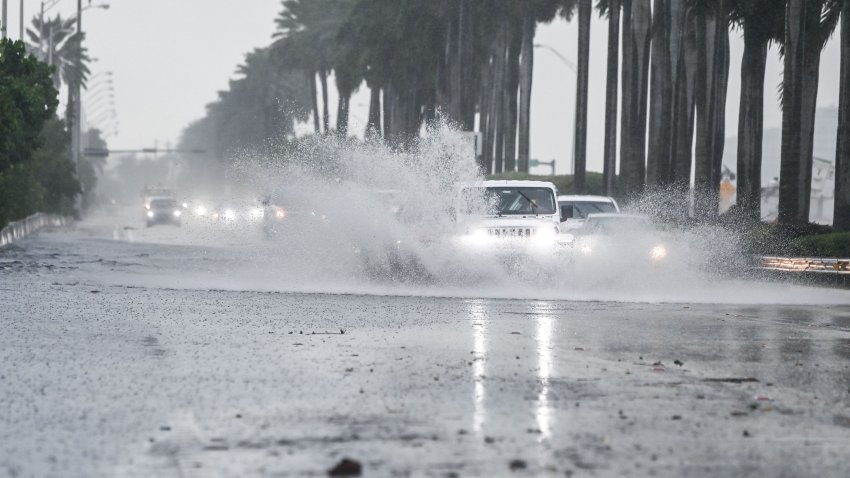 Cars drive through the flooded street during heavy rain and wind as tropical storm Eta approaches the south of Florida, in Miami, Florida on November 9, 2020. – Tropical storm Eta brought strong winds and torrential rain to Cuba on Sunday after having cut a destructive and deadly path through parts of Central America and southern Mexico. (Photo by CHANDAN KHANNA / AFP) (Photo by CHANDAN KHANNA/AFP via Getty Images)