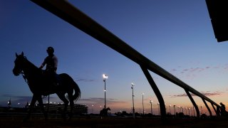 A horse is ridden back to a barn after an early-morning workout at Churchill Downs, April 27, 2021, in Louisville, Ky. The 147th running of the Kentucky Derby is scheduled for Saturday, May 1.