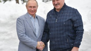 Russian President Vladimir Putin (L) shakes hands with Belarus President Alexander Lukashenko