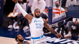 Los Angeles Lakers forward LeBron James (23) goes up high to dunk the ball during the first half of an NBA basketball game against the Indiana Pacers in Indianapolis