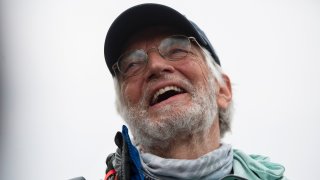 American climber Arthur Muir, 75, gestures as he arrives in Kathmandu, Nepal, Sunday, May 30, 2021. The retired attorney from Chicago who became the oldest American to scale Mount Everest, and a Hong Kong teacher who is now the fastest female climber of the world's highest peak, on Sunday returned safely from the mountain where climbing teams have been struggling with bad weather and a coronavirus outbreak. Arthur Muir, 75, scaled the peak earlier this month, beating the record by another American, Bill Burke, at age 67.