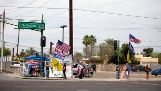 Protestors in support of former President Donald Trump gather outside Veterans Memorial Coliseum where Ballots from the 2020 general election wait to be counted on May 1, 2021 in Phoenix, Arizona.