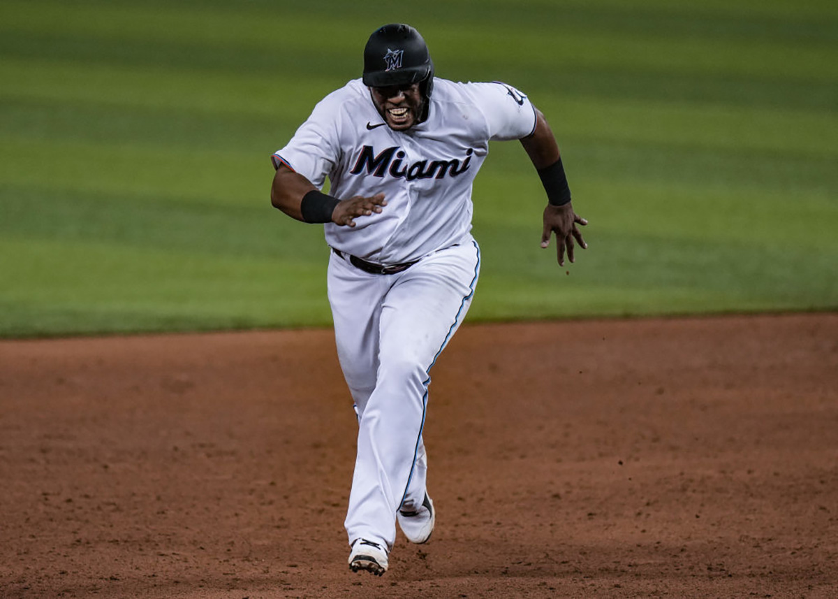 Miami Marlins' Lewis Brinson (9) strikes out with runners on base