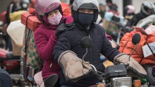 Chinese migrant workers rest at a gas station after riding motorcycles on January 25, 2019 in Zhaoqing, Guangdong Province, China.