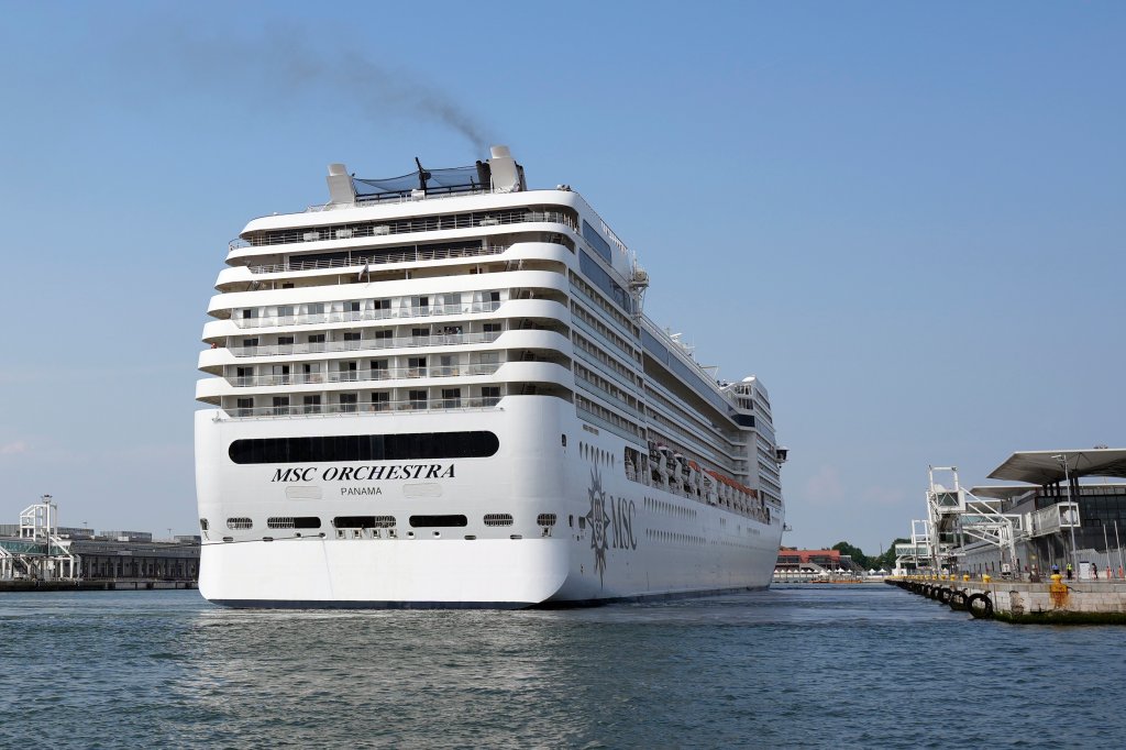 The the 92,409-ton, 16-deck MSC Orchestra cruise ship exits the lagoon as it leaves Venice, Italy