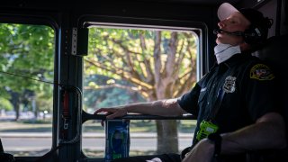 Salem Fire Department paramedic Justin Jones tries to stay cool after responding to a heat exposure call during a heat wave