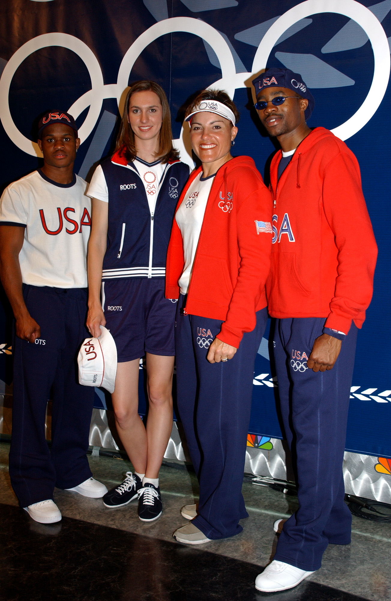 United States Olympic athletes, from left, boxer Rock Allen, softball player Jennifer Nicholas, archer Lisa Fernandez, and fencer Ivan Lee model the new 2004 Olympic Sportswear collection on May 13, 2004, at NBC Studios in New York.