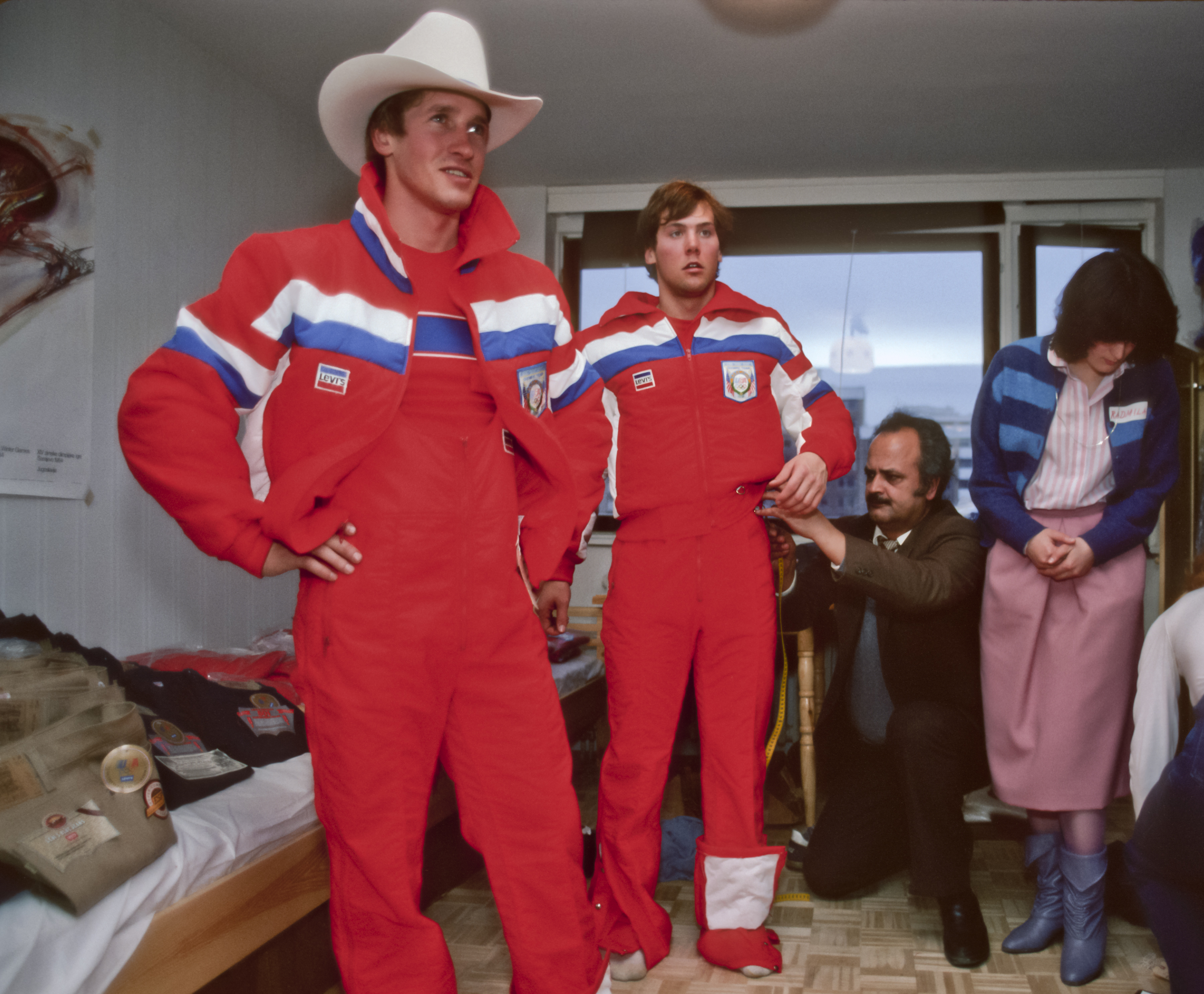 Alpine skiers Bill Johnson (wearing hat) and Doug Lewis of the USA Olympic Team try on their Olympic uniforms prior to the 1984 Winter Olympics held in Sarajevo, Yugoslavia.