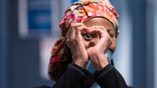 A health care workers forms a heart inside the temporary hospital located at the USTA Billie Jean King National Tennis Center during the outbreak of the coronavirus disease (COVID-19), in the Queens borough on April 10, 2021