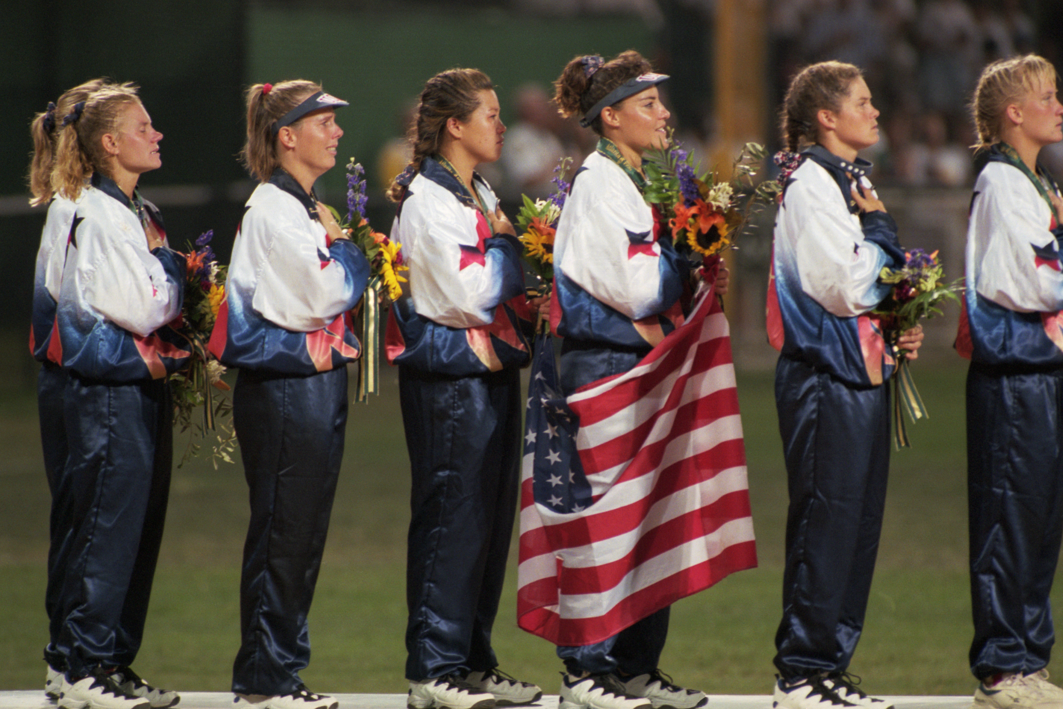 The US women's softball team waves to the crowd after being awarded the gold medal at the 1996 Atlanta Olympic Games.