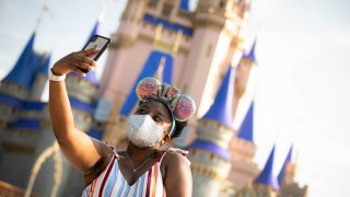 A guest takes a selfie at Magic Kingdom Park at Walt Disney World Resort on July 11, 2020.