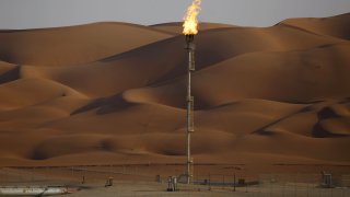 Flames burn off at an oil processing facility in Saudi Aramco’s oilfield in the Rub’ Al-Khali desert in Shaybah, Saudi Arabia, in October 2018.