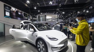 Visitors looking at a China-made Tesla Model Y electric vehicle at the Auto Shanghai 2021 show in Shanghai, China, on April 27, 2021.