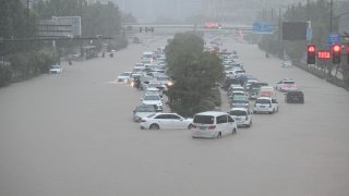Vehicles are stranded in floodwater near Zhengzhou Railway Station on July 20, 2021 in Zhengzhou, Henan Province of China.
