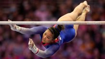Suni Lee competes on the uneven bars