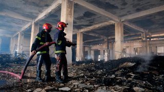 Firefighters work to douse a fire at a food and beverage factory in Rupganj, outside Dhaka, Bangladesh, Friday, July 9, 2021. At least 52 people died in a huge blaze that engulfed a food and beverage factory outside Bangladesh's capital, fire officials said Friday, in the latest industrial disaster to hit the South Asian nation.