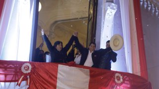 Pedro Castillo, center, celebrates with his running mate Dina Boluarte after being declared president-elect by election authorities in Lima, Peru, Monday, July 19, 2021. Castillo was declared the winner more than a month after elections took place and after opponent Keiko Fujimori claimed that the election was tainted by fraud.