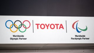 This picture shows a Toyota and Olympic and Paralympic games logos at a closed Toyota showroom in Tokyo on May 12, 2021.
