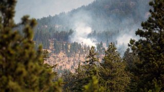 A wildfire burns near Lytton, British Columbia, Canada, on Friday, July 2, 2021. Canadian Prime Minister Justin Trudeau called an emergency meeting of a crisis committee to address the wildfires that are raging through the western part of the country as a heat wave shatters record.