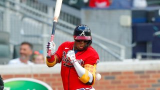 ATLANTA, GA – JULY 02: Ronald Acuna Jr. #13 of the Atlanta Braves is hit by the first pitch in the first inning of an MLB game against the Miami Marlins at Truist Park on July 2, 2021 in Atlanta, Georgia. (Photo by Todd Kirkland/Getty Images)