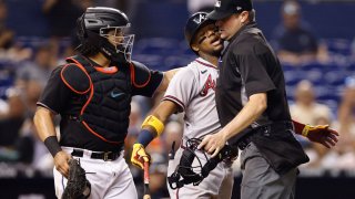 MIAMI, FLORIDA – JULY 09: Umpire Jordan Baker #71 holds back Ronald Acuna Jr. #13 of the Atlanta Braves after he was hit by a pitch from Anthony Bender #80 of the Miami Marlins (not pictured) during the seventh inning at loanDepot park on July 09, 2021 in Miami, Florida. (Photo by Michael Reaves/Getty Images)
