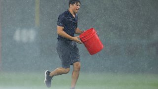 PHILADELPHIA, PA – JULY 17: A Philadelphia Phillies groundskeeper during a thunder storm that interrupted play during the tenth inning of a game against the Miami Marlins at Citizens Bank Park on July 17, 2021 in Philadelphia, Pennsylvania. (Photo by Rich Schultz/Getty Images)