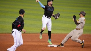 MIAMI, FLORIDA – JULY 24: Miguel Rojas #19 of the Miami Marlins fields the ball for a double play as Trent Grisham #2 of the San Diego Padres fails to slide into second base in the ninth inning at loanDepot park on July 24, 2021 in Miami, Florida. The Miami Marlins challenged the call of not being out at first base for slide interfernce and it was overturned. (Photo by Mark Brown/Getty Images)