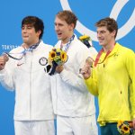 Gold medalist Chase Kalisz of USA, silver medalist Jay Litherland of USA and bronze medalist Brendon Smith of Australia hold up their medals during the medals ceremony of the 400m individual medley final on day two of the Tokyo 2020 Olympic Games at Tokyo Aquatics Centre on July 25, 2021 in Tokyo, Japan.