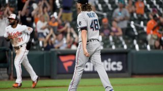 BALTIMORE, MARYLAND – JULY 28: Steven Okert #48 of the Miami Marlins walks off the field as Cedric Mullins #31 of the Baltimore Orioles scores to win the game during the ninth inning at Oriole Park at Camden Yards on July 28, 2021 in Baltimore, Maryland. (Photo by Will Newton/Getty Images)