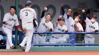 Japan celebrates a 3-2 walk-off victory against the Dominican Republic in the opening game of the Tokyo Olympics baseball tournament.