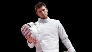 Jul 24, 2021; Chiba, Japan; Junghwan Kim (KOR) defeats Eli Dershwitz (USA) in the men's sabre individual table of 16 during the Tokyo 2020 Olympic Summer Games at Makuhari Messe Hall B.