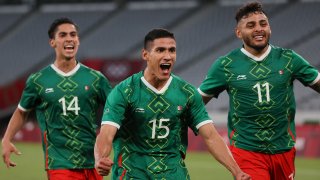 Mexico forward Uriel Antuna (center) celebrates with forward Alexis Vega (right) and midfielder Erick Aguirre after scoring the third goal during the Tokyo 2020 Olympic Games men's group A first round football match between Mexico and France at Tokyo Stadium.