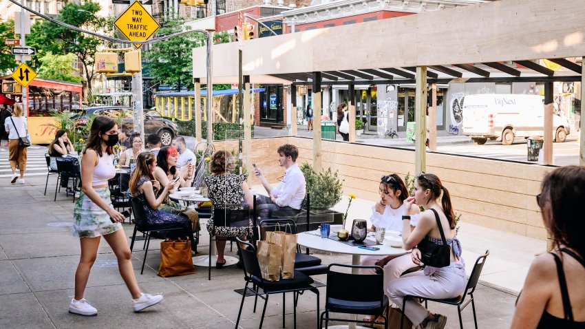 Pedestrians sit in the outdoor dining section of a restaurant in the SoHo neighborhood of New York, U.S., on Wednesday, May 19, 2021. Photographer: Nina Westervelt/Bloomberg via Getty Images